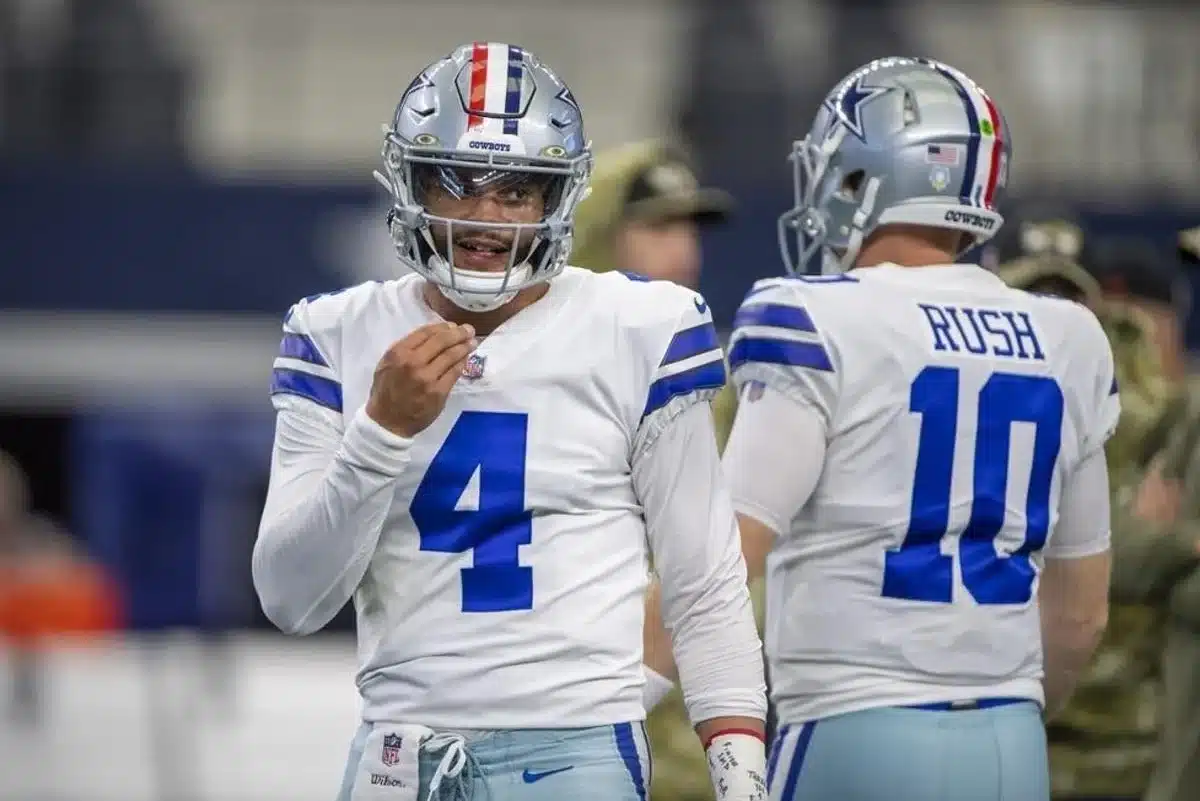 Dallas Cowboys quarterback Cooper Rush (10) hands the ball off