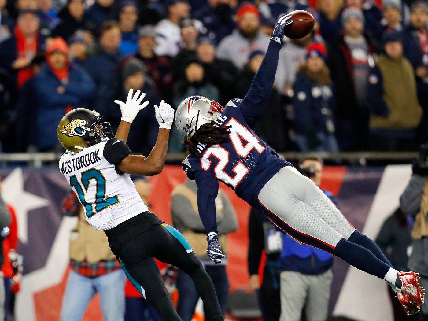 Stephon Gilmore making an interception while playing for the New England Patriots