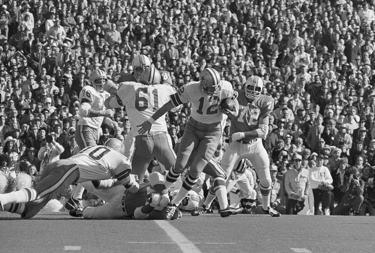 Jim Kiick of the Miami Dolphins gets tackled by Cornell Green of