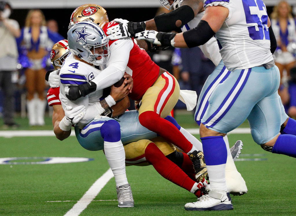 ARLINGTON, TEXAS - JANUARY 16: Samson Ebukam #56 and Nick Bosa #97 of the San Francisco 49ers sack Dak Prescott #4 of the Dallas Cowboys during the first quarter in the NFC Wild Card Playoff game at AT&T Stadium on January 16, 2022 in Arlington, Texas. (Photo by Richard Rodriguez/Getty Images)