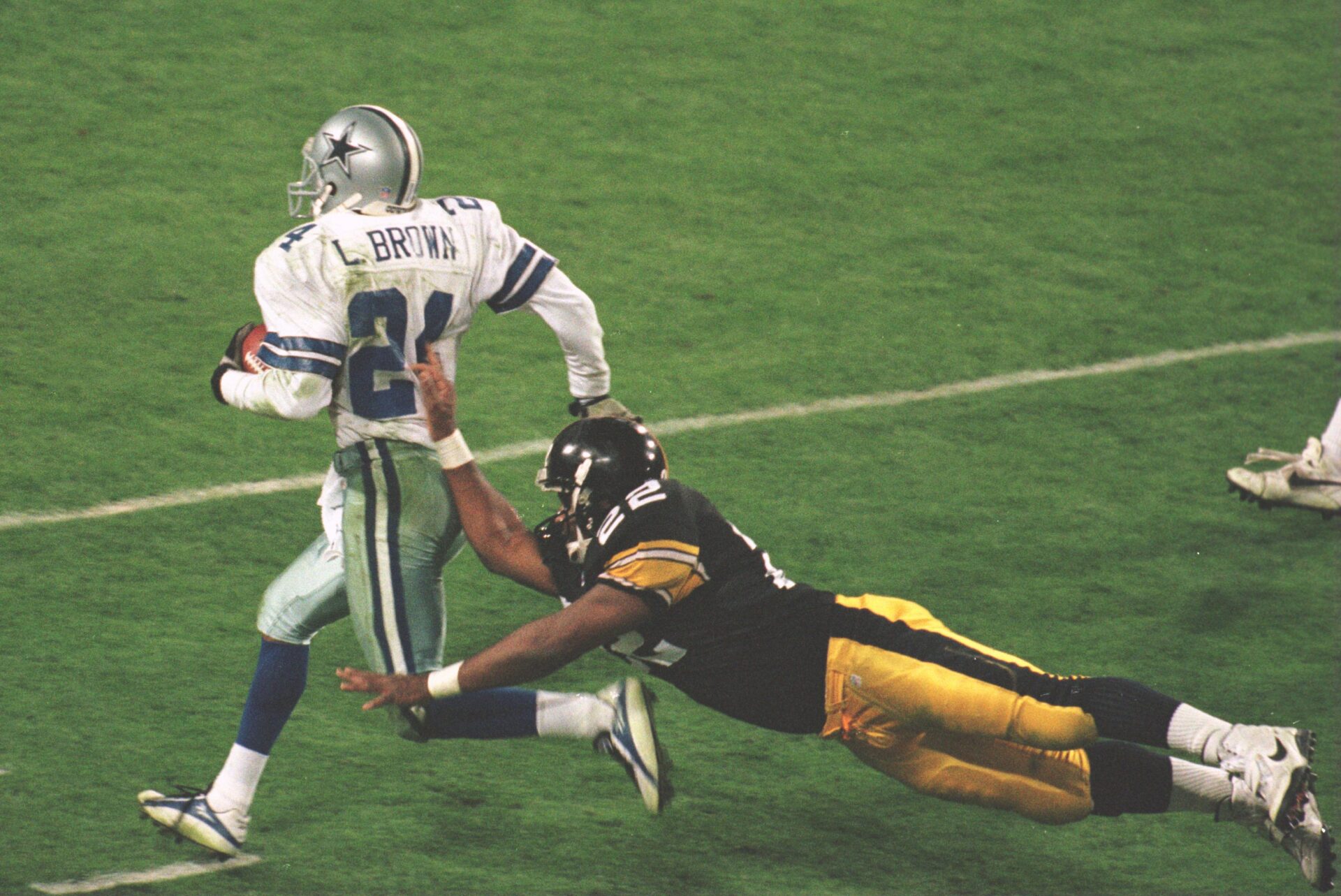 28 Jan 1996: Cornerback Larry Brown #24 of the Dallas Cowboys is knocked out of bounds by running back John L. Williams #22 of the Pittsburgh Steelers during the 4th quarter of the Cowboys game versus the Pittsburgh Steelers in Super Bowl XXX at Sun Devi