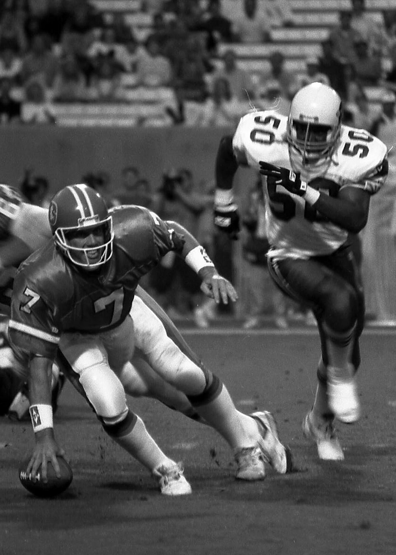 Denver Broncos quarterback John Elway eludes pressure during a 1993 preseason game against the Arizona Cardinals at Sun Devil Stadium in Tempe, AZ. (Photo by Richard Paolinelli)