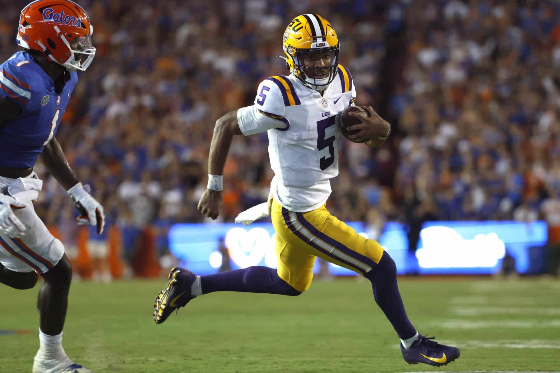 Oct 15, 2022; Gainesville, Florida, USA; LSU Tigers quarterback Jayden Daniels (5) runs with the ball against the Florida Gators during the second half at Ben Hill Griffin Stadium. Mandatory Credit: Kim Klement-USA TODAY Sports