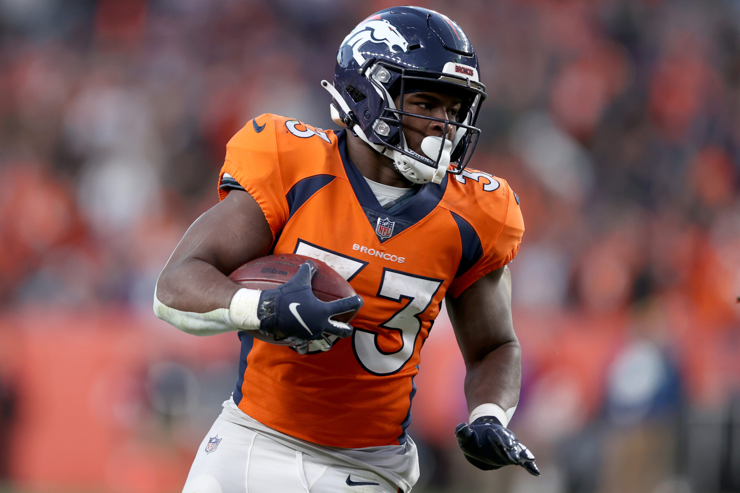 DENVER, COLORADO - DECEMBER 19: Javonte Williams #33 of the Denver Broncos carries the ball against the Cincinnati Bengals at Empower Field At Mile High on December 19, 2021 in Denver, Colorado. (Photo by Matthew Stockman/Getty Images)