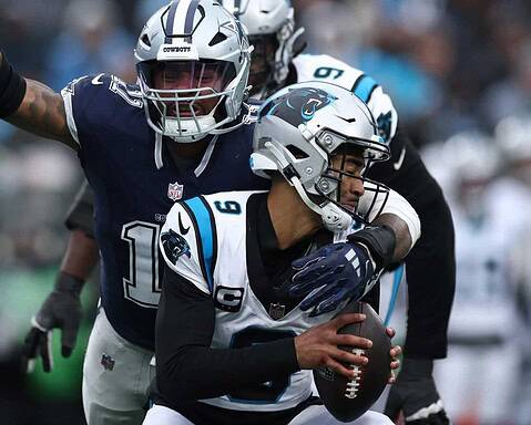 Donovan Peoples-Jones catches a football during an NFL game between the Dallas Cowboys and the Carolina Panthers, showcasing American football action and player team uniforms.