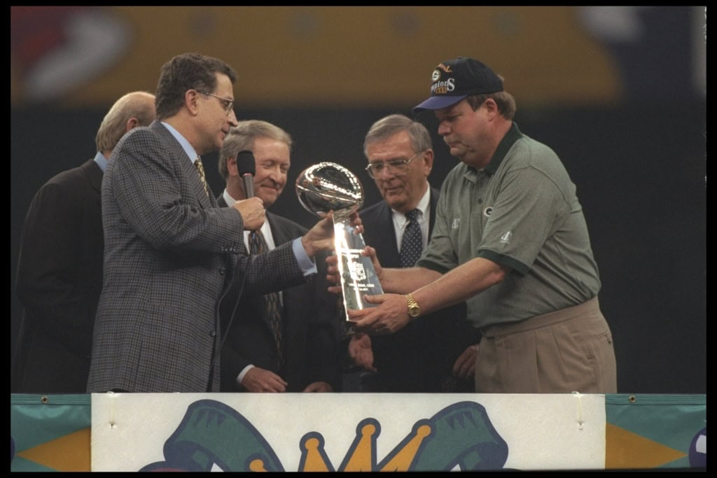 NFL COmmissioner Paul Tagliabue hands the Lombardi Trophy to the Green Bay Packers head coach Mike Holgrem