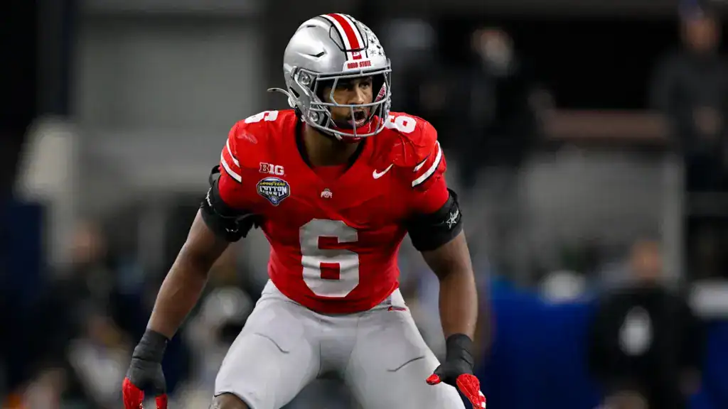 Ohio State linebacker Sonny Styles lines up in a low pre-snap stance, reading the offense during a college football game.