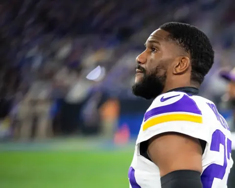 Cornerback Fabian Moreau looking on from the sideline in a Minnesota Vikings uniform during an NFL game.