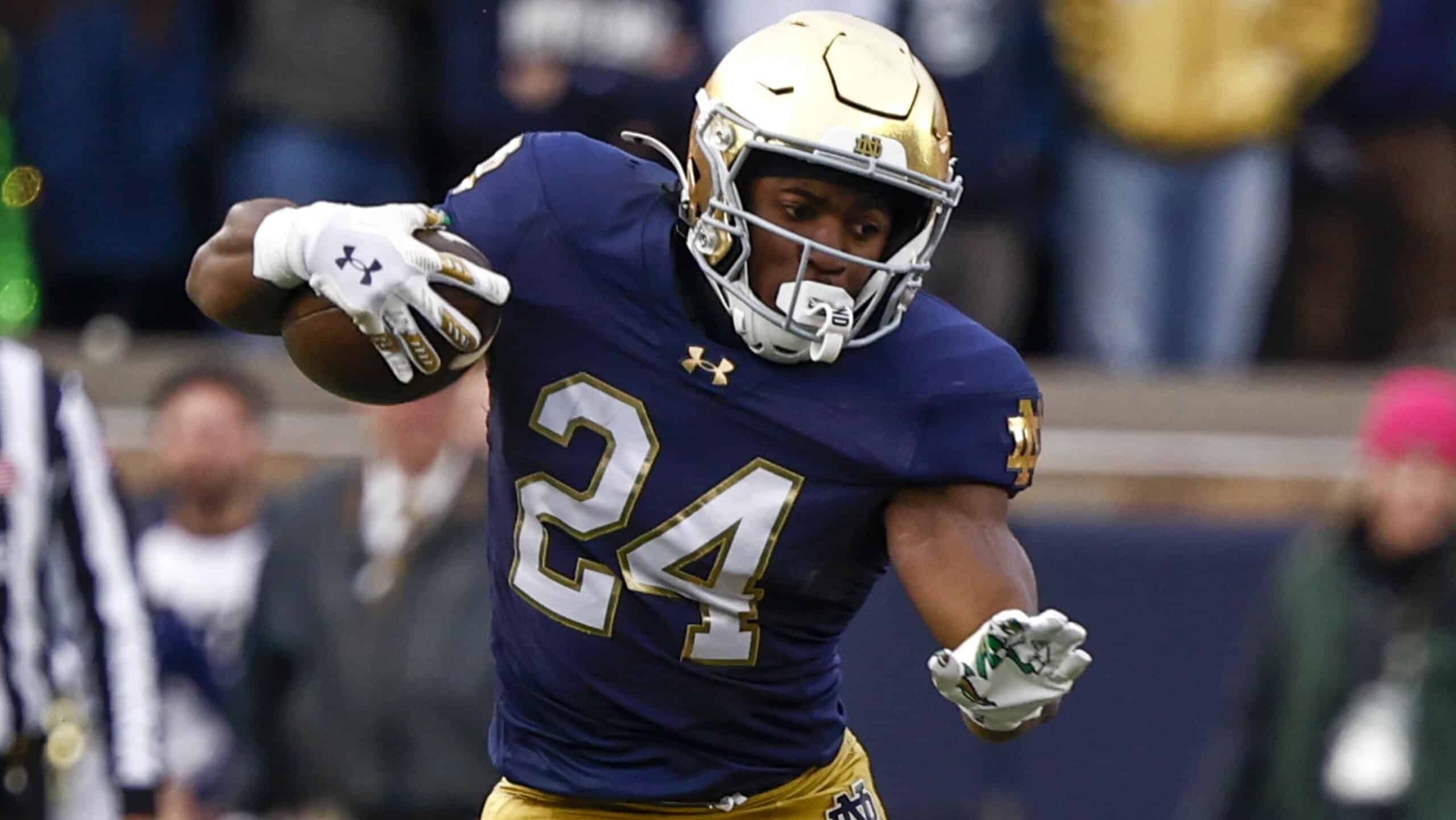 Jadarian Price cuts laterally with the football, showcasing agility and contact balance for Notre Dame.