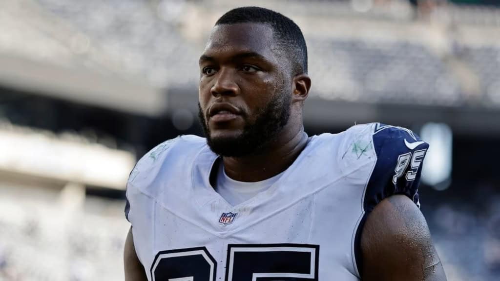 Close-up of Kenny Clark in his Dallas Cowboys uniform, focused before kickoff at AT&T Stadium.