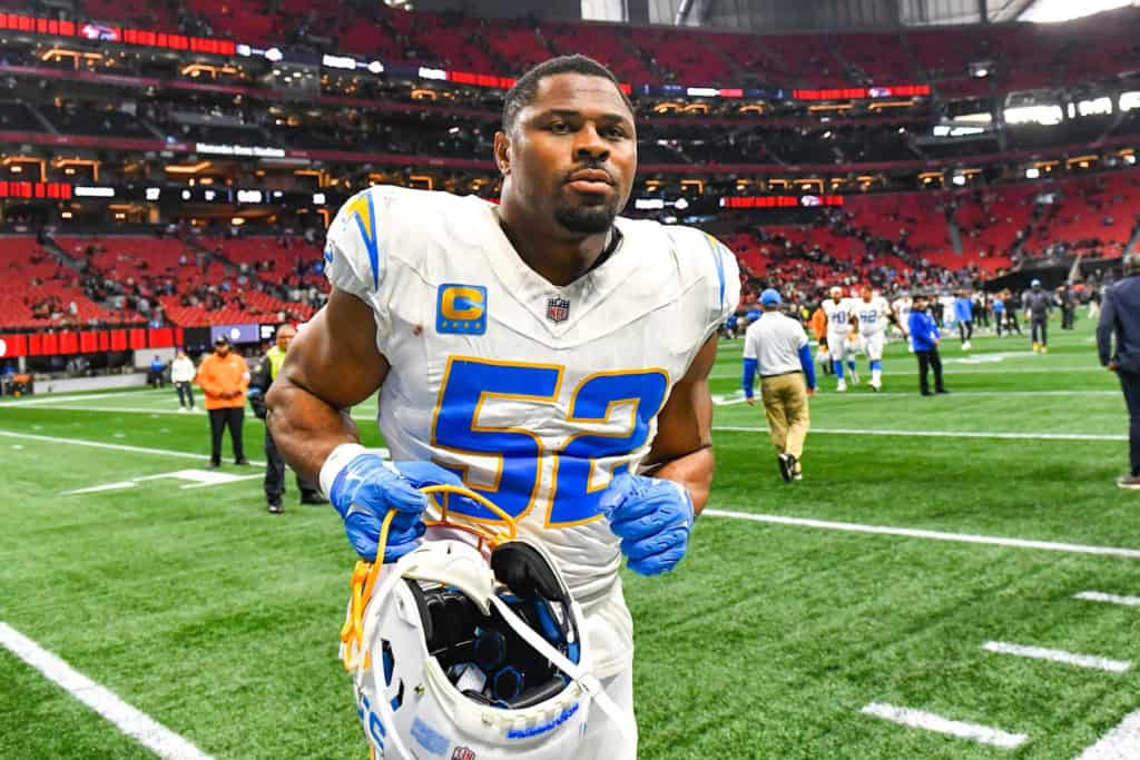 Los Angeles Chargers linebacker wearing number 52 walking off the field holding his helmet inside an NFL stadium, veteran free agent linebacker.