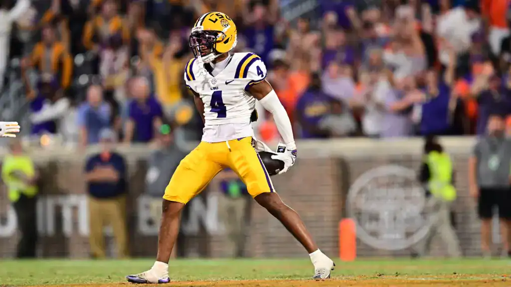 LSU defensive back Mansoor Delane reacts after a turnover during a night game, boosting his visibility in early NFL mock draft projections.