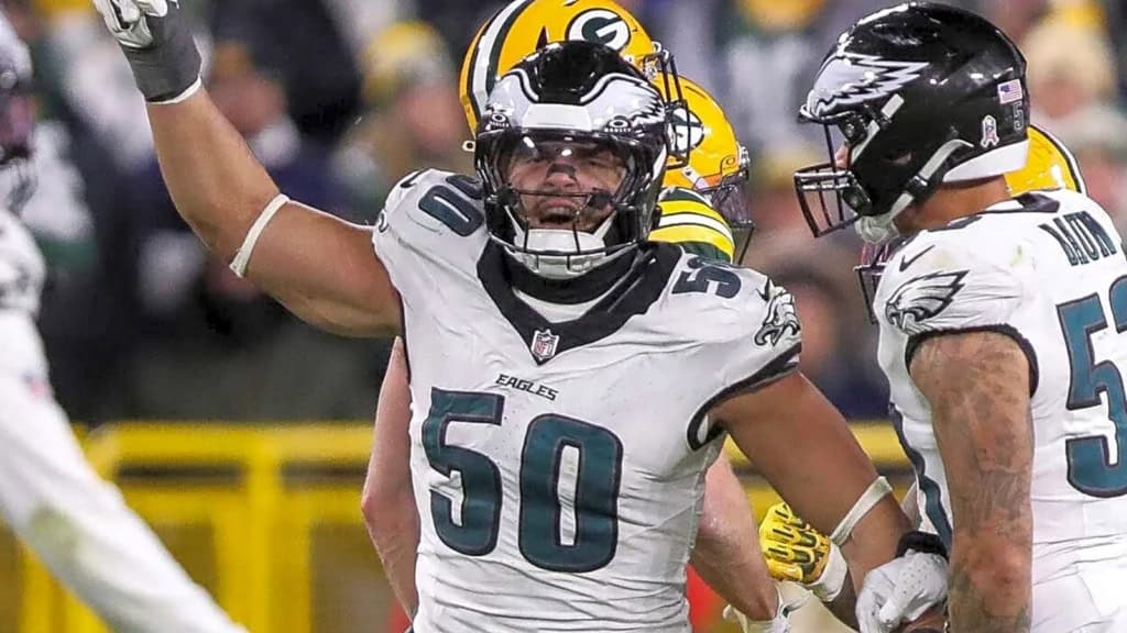Jaelan Phillips celebrating a defensive play in a Philadelphia Eagles white away uniform during an NFL game.