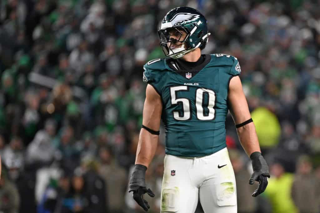 Jaelan Phillips standing on the field in a green Philadelphia Eagles home jersey before kickoff.