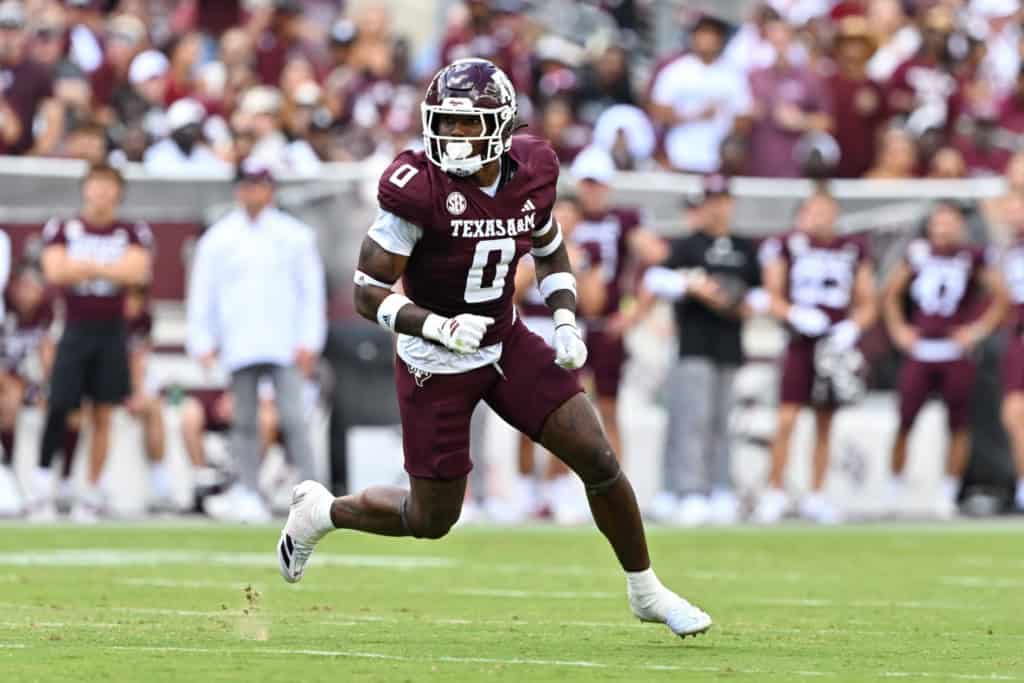 Scooby Williams sprinting across the field in a Texas A&M jersey, showcasing speed and pursuit ability on defense.