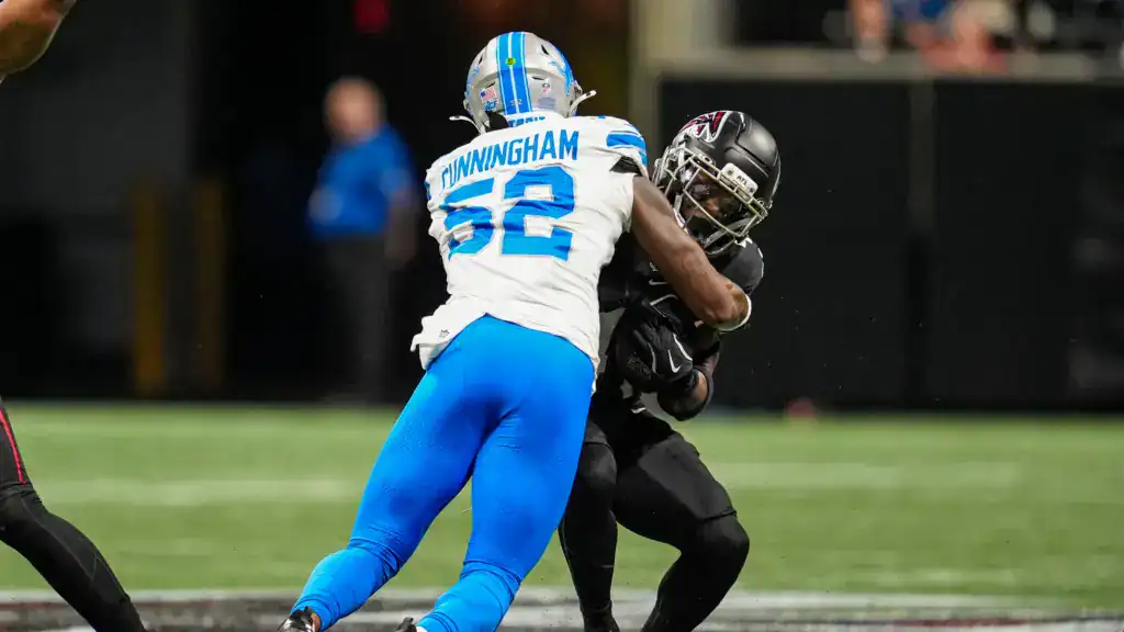 Detroit Lions linebacker wearing number 52 wrapping up a ball carrier during an NFL game, free agent linebacker in live game action.