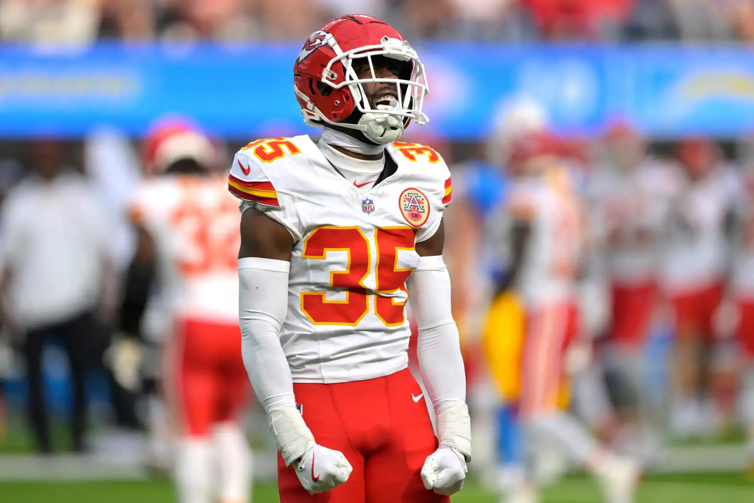 Kansas City Chiefs defensive back in the secondary celebrates during an NFL game, showing emotion after a big play in coverage.