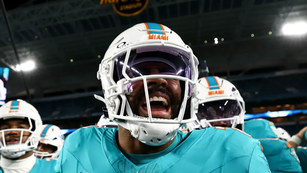 Miami Dolphins linebacker Jordyn Brooks celebrates in a close-up tunnel shot before an NFL game.