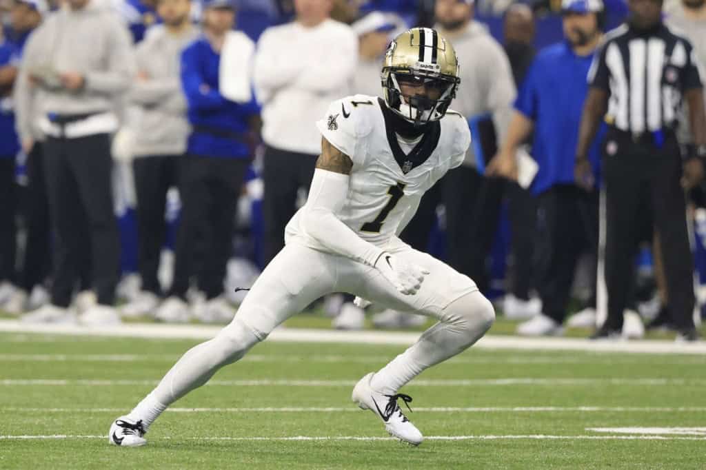 Alontae Taylor playing cornerback for the New Orleans Saints during an NFL game, breaking on the ball in coverage.