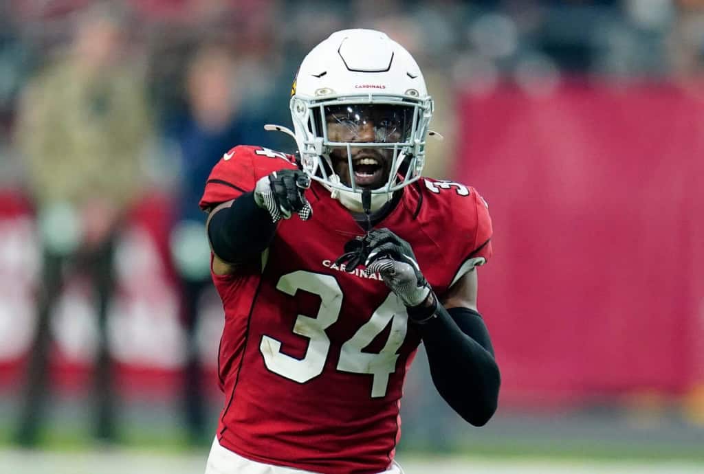 Dallas Cowboys defensive changes highlighted by a Cardinals defensive back in red during an NFL game.