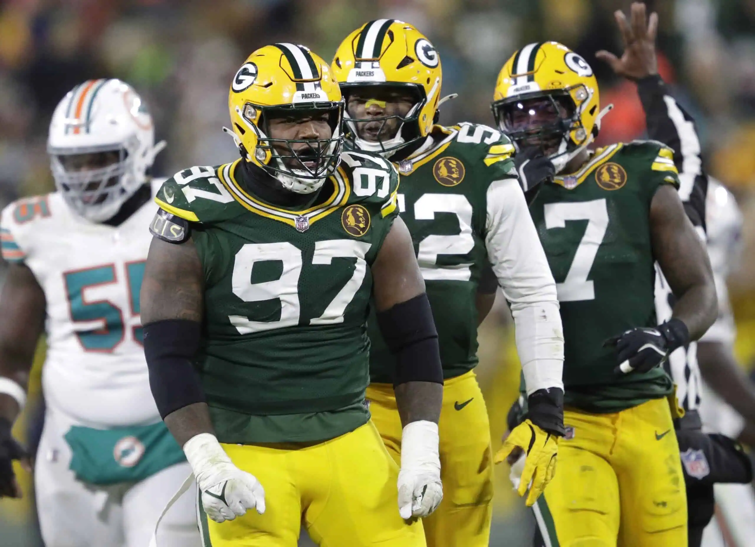Kenny Clark celebrating with Packers defense in image showing why the Rashan Gary and Kenny Clark trade combined is a win for the Cowboys