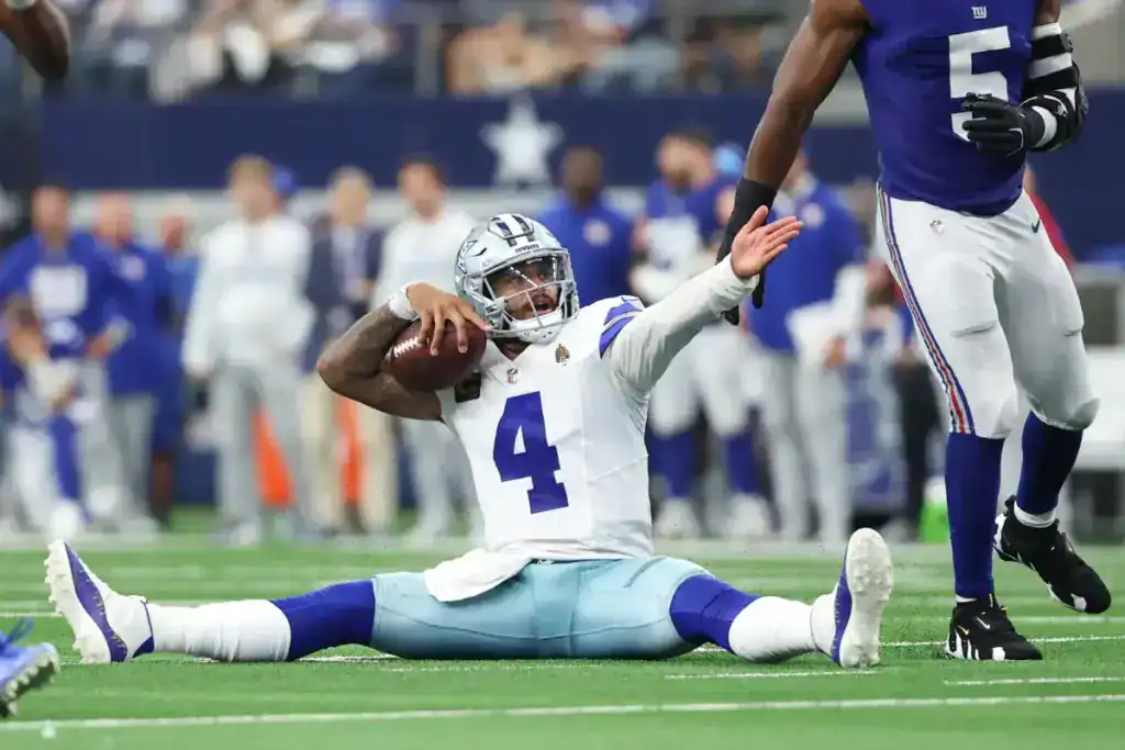 Dak Prescott celebrates from the turf against the Giants in a game tied to the Dak Prescott and bad defenses conversation