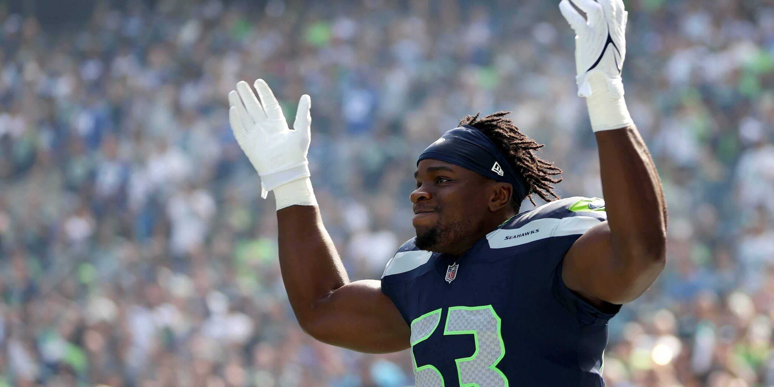 Boye Mafe Seattle Seahawks edge rusher celebrating a defensive stop during an NFL game.