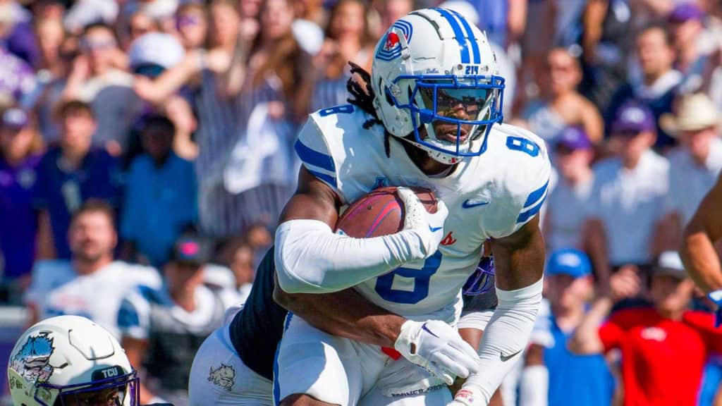 SMU wide receiver Jordan Hudson (#8) carrying the football through defenders during an SMU football game