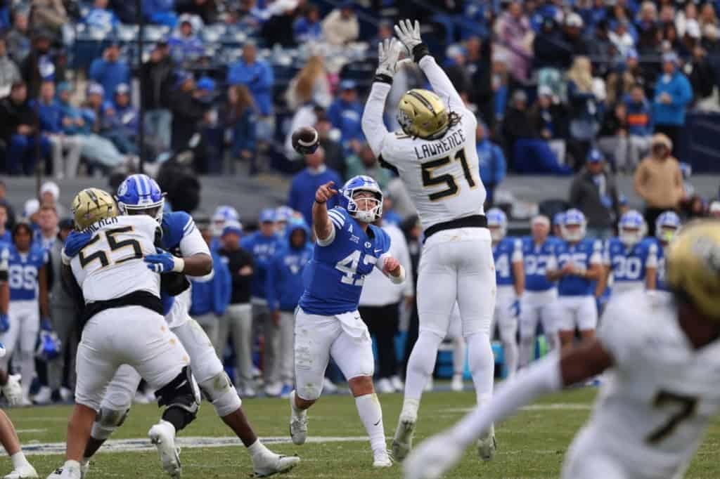 UCF defensive lineman Malachi Lawrence (#57) jumps to deflect a pass against BYU during a Big 12 college football game.