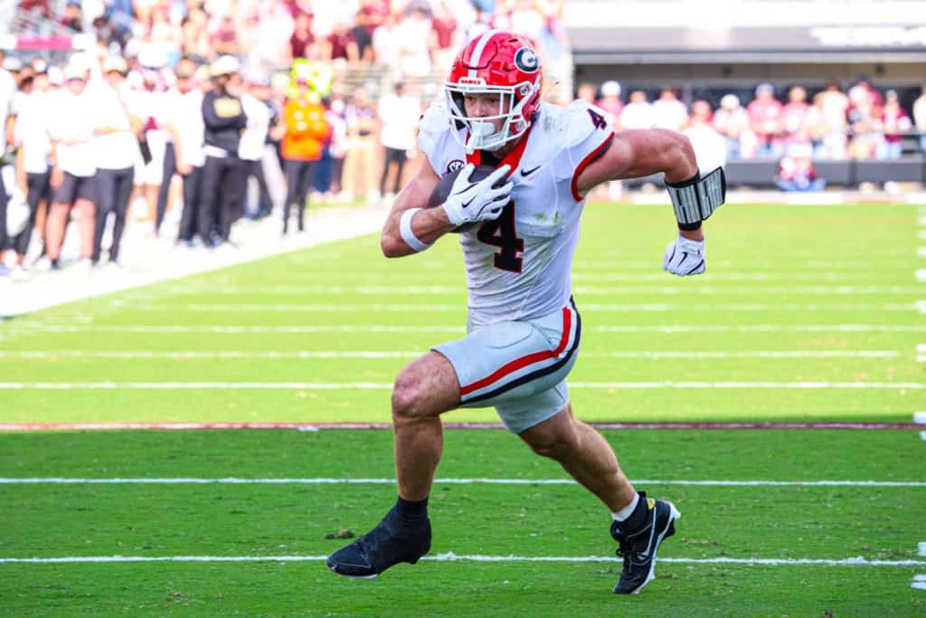 Georgia offensive player #4 running with the football in open field during a college football game