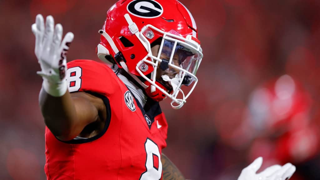 Georgia offensive player #8 in red uniform reacting after a play during an SEC college football game