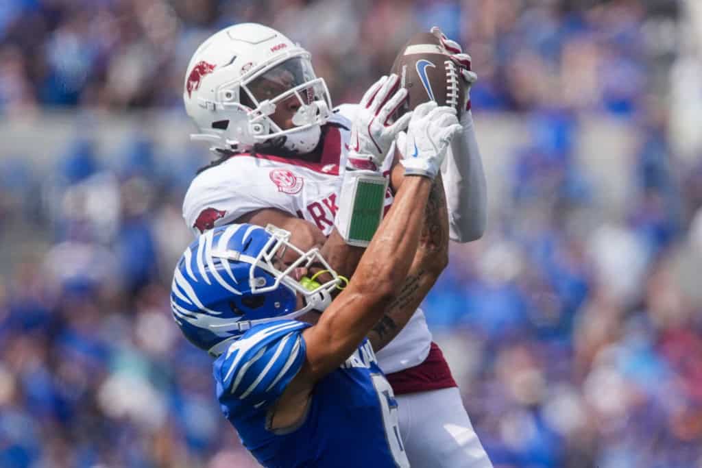 Arkansas cornerback goes to contest a catch against a Kentucky wide receiver, spotlighted as a defensive weapon in a 2026 NFL Mock Draft.
