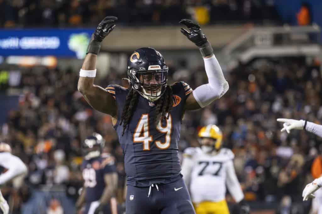 Chicago Bears linebacker Tremaine Edmunds celebrating a defensive play with arms raised during an NFL game