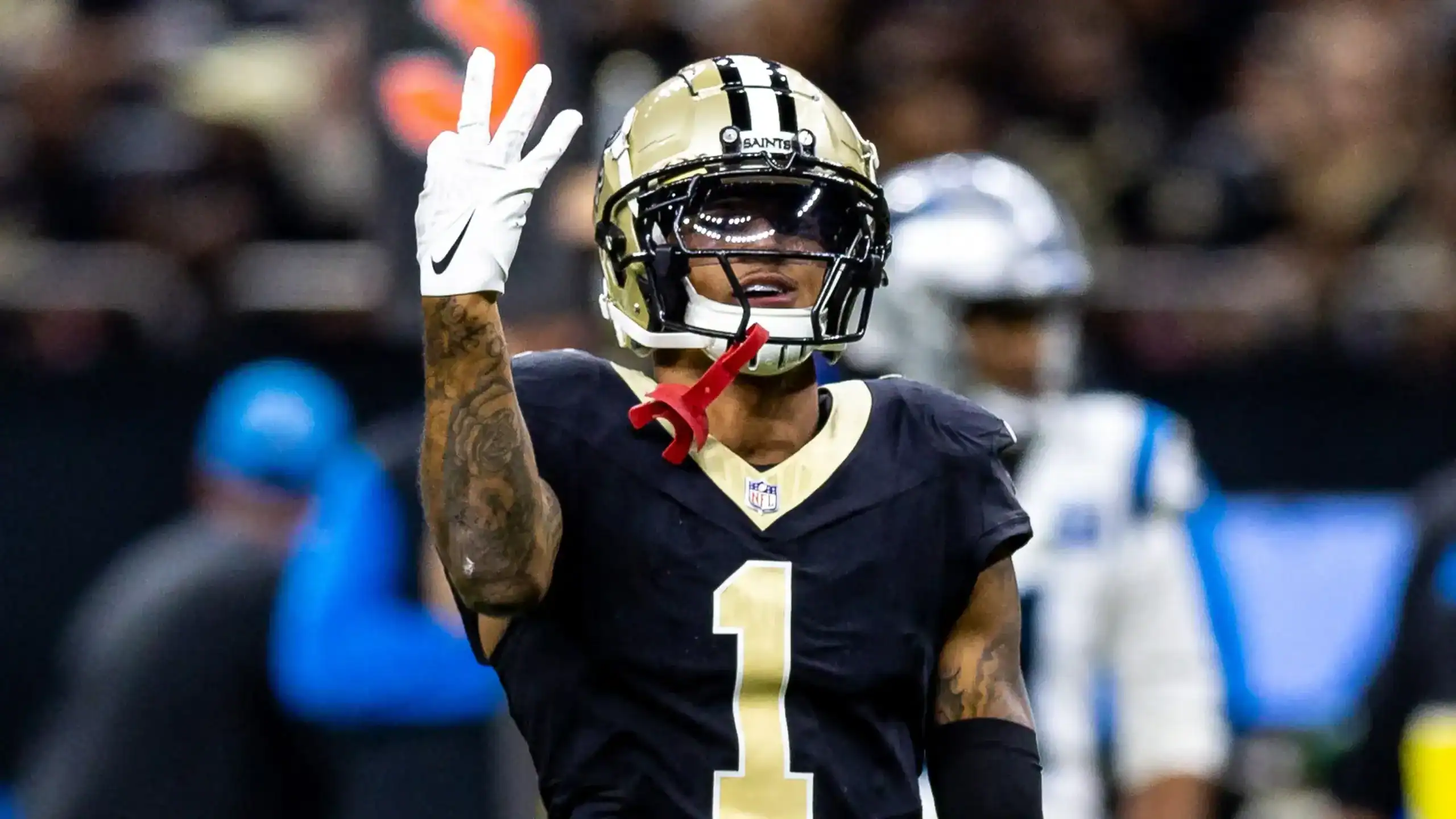 Alontae Taylor signaling after a defensive play while wearing his New Orleans Saints jersey during an NFL matchup.