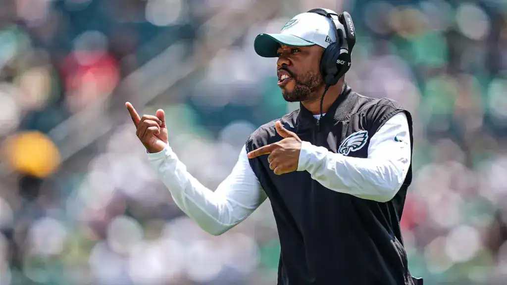 New Cowboys defensive coordinator Christian Parker coaching on the sideline in Philadelphia Eagles gear