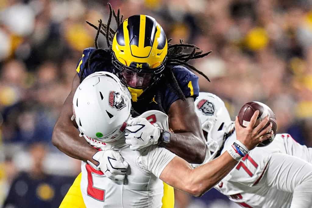 Jaishawn Barham Michigan linebacker sacks the quarterback during a college football game before being drafted by the Dallas Cowboys