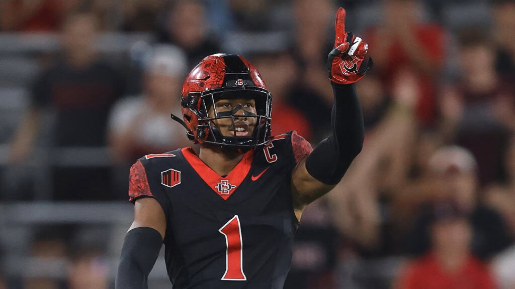 2026 NFL Draft prospect Chris Johnson points upward while wearing San Diego State’s black uniform.