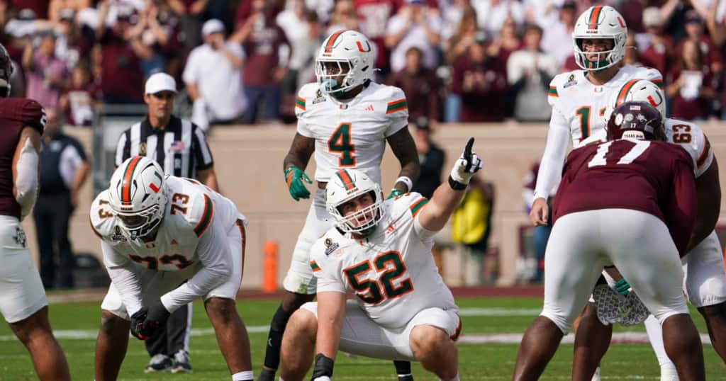 2026 NFL Draft sleeper James Brockermeyer points out protection for Miami at the line of scrimmage, surrounded by teammates in white uniforms against Texas A&M.