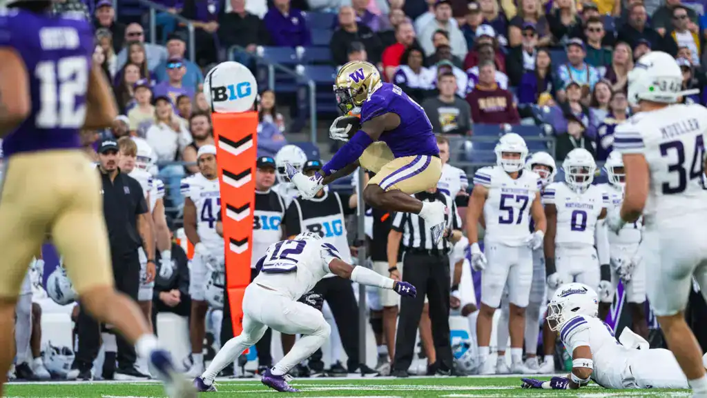 2026 NFL Draft prospect Jonah Coleman makes a strong run while defenders close in around him.