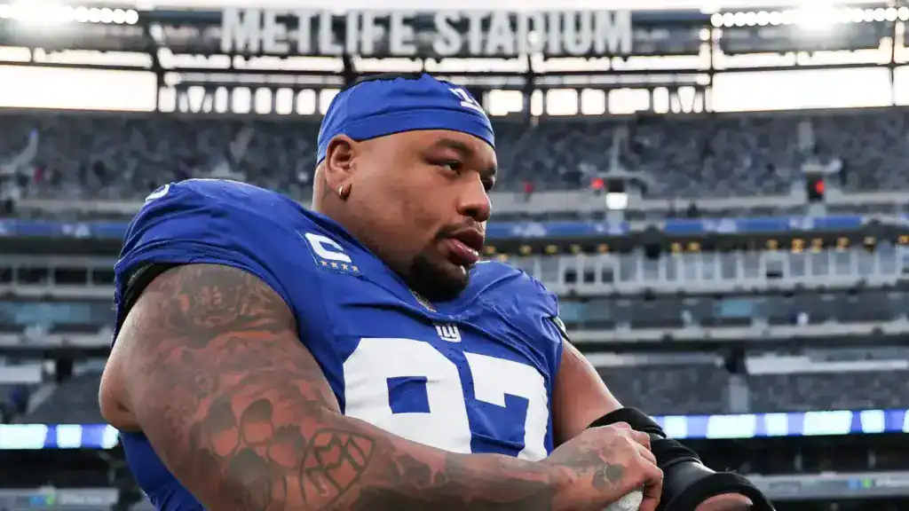 Dexter Lawrence stands on the sideline in New York Giants gear at MetLife Stadium before a game.