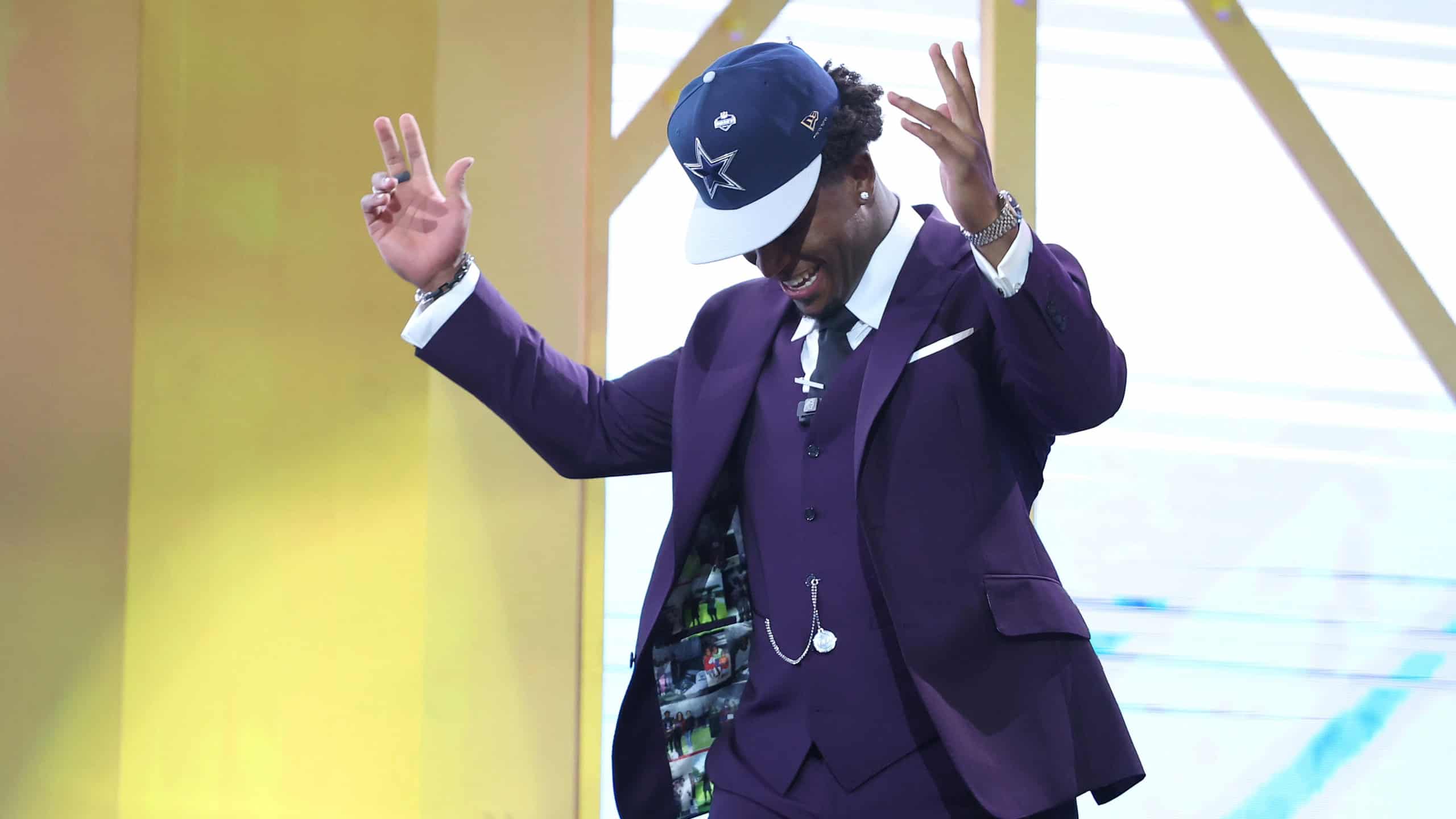 Rookie Caleb Downs celebrates on stage wearing a Dallas Cowboys hat after being selected in the 2026 NFL Draft.