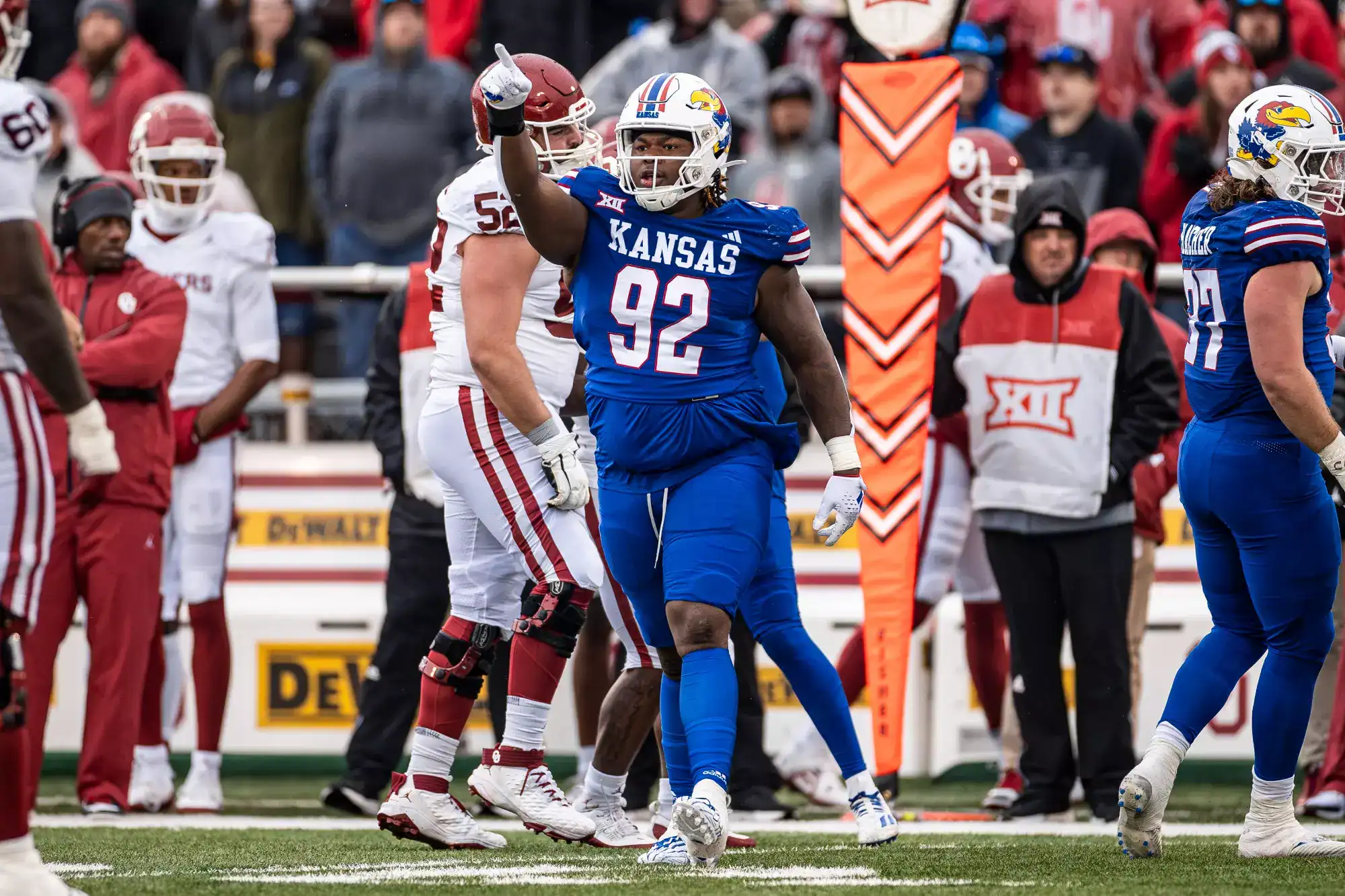 Kansas defensive lineman Tommy Dunn Jr. (#92) celebrates during a college game, signed by the Dallas Cowboys as an undrafted free agent.