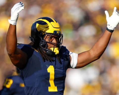 Jaishawn Barham Michigan Wolverines linebacker celebrating a big defensive play during a home game