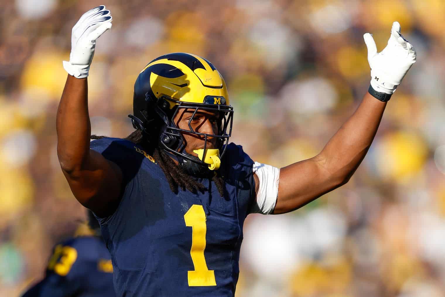 Jaishawn Barham Michigan Wolverines linebacker celebrating a big defensive play during a home game