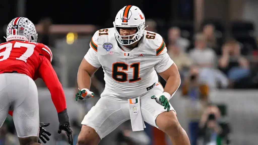 Miami tackle Francis Mauigoa sets up at the line of scrimmage in a white Hurricanes uniform against Ohio State, featuring an elite 2026 NFL Draft prospect in action.