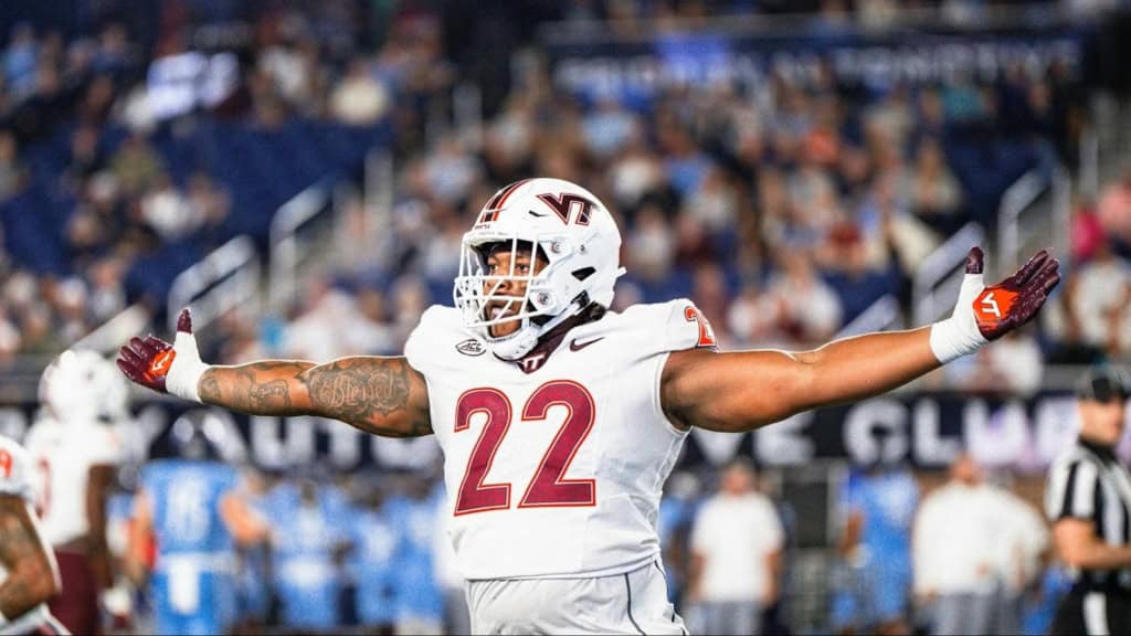 Virginia Tech defensive lineman Kelvin Gilliam (#22) celebrates a defensive stop, signed by the Dallas Cowboys as an undrafted free agent.