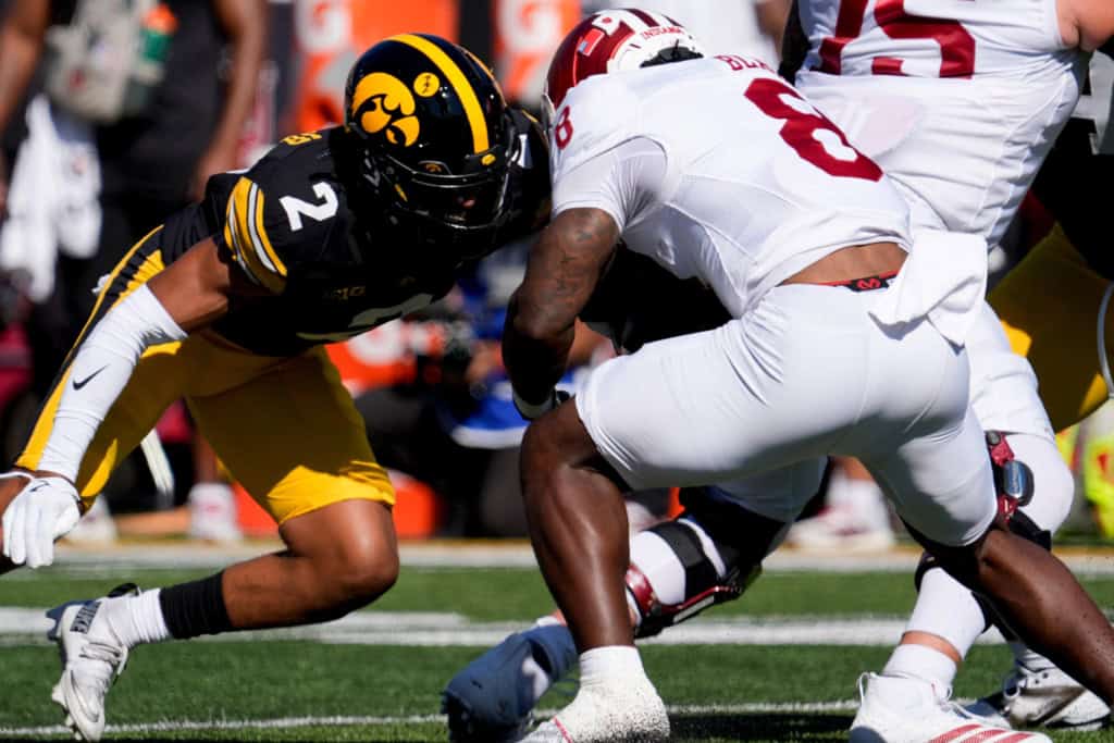 2026 NFL Draft sleeper TJ Hall lowers into a tackle for Iowa, meeting an Indiana ball carrier near the line of scrimmage.