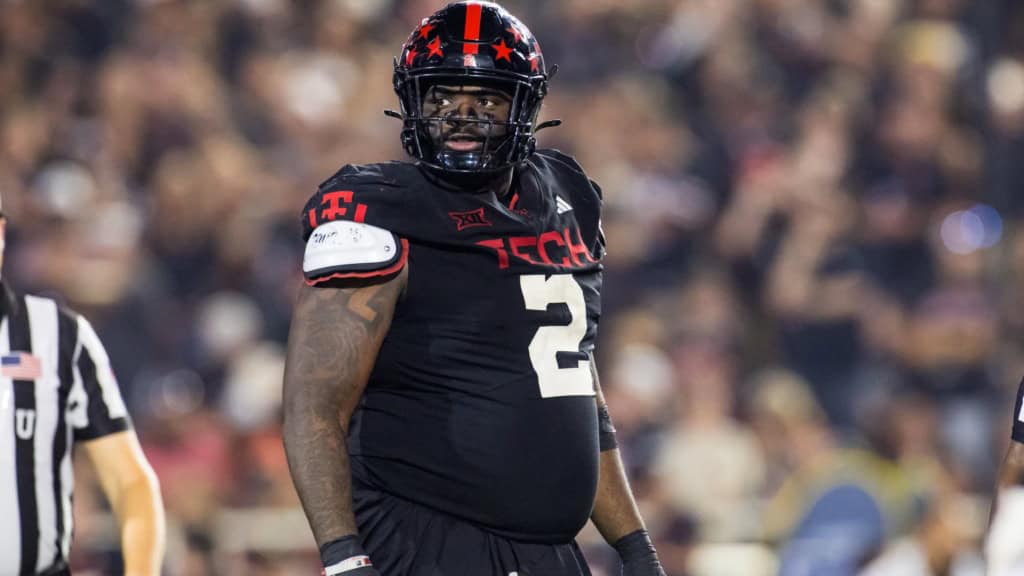 Lee Hunter, Texas Tech draft prospect, standing on the field in a black Red Raiders uniform during a game.