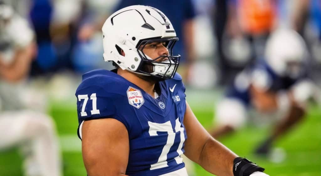 Olaivavega Ioane, Penn State offensive lineman and 2026 NFL Draft prospect, looks on from the field in a blue Nittany Lions uniform.