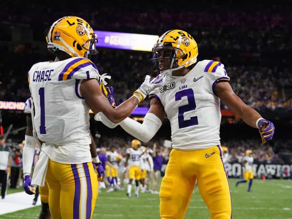 LSU Tigers players celebrate on the field during a championship game, highlighting university draft picks that earned First Team All-Pro recognition.